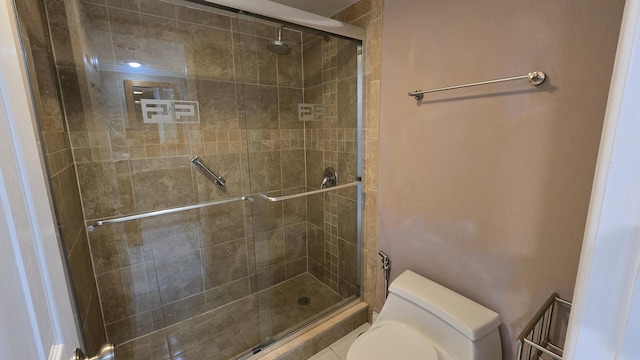 bathroom featuring toilet and walk in shower