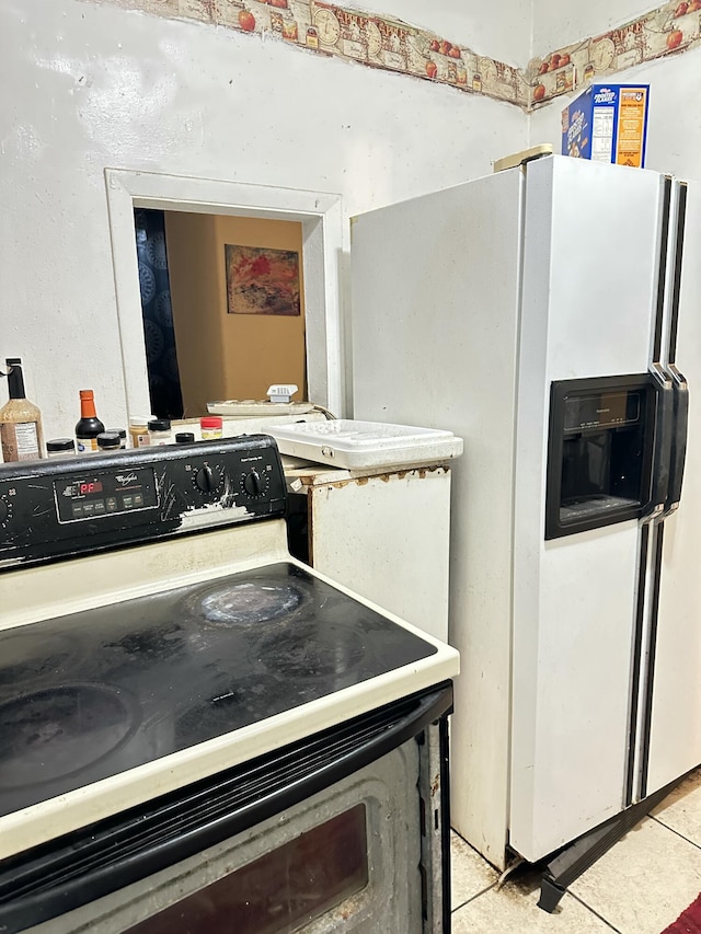 kitchen featuring white appliances and light tile patterned floors