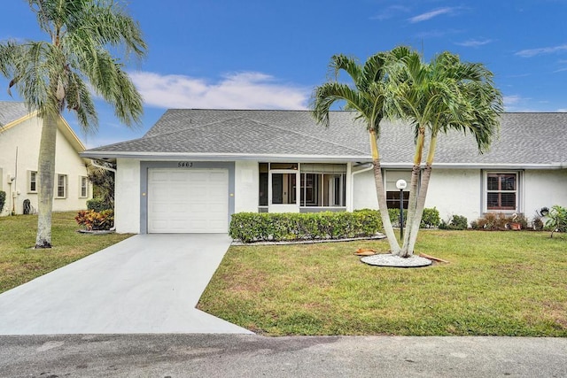 ranch-style home with a front yard and a garage