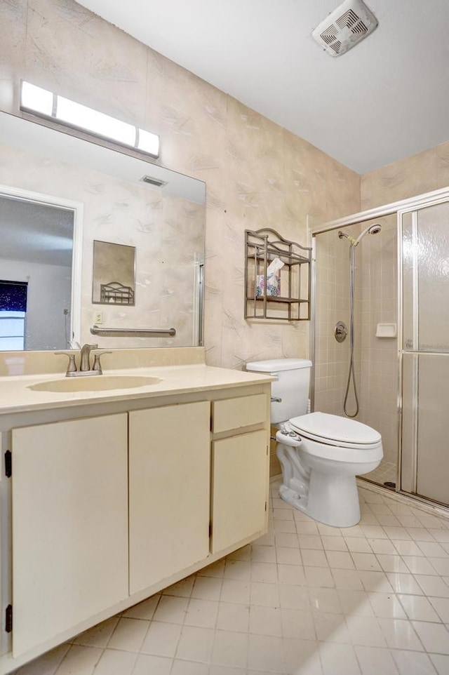 bathroom with vanity, toilet, and a shower with shower door