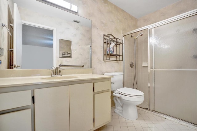 bathroom with vanity, toilet, and a shower with shower door