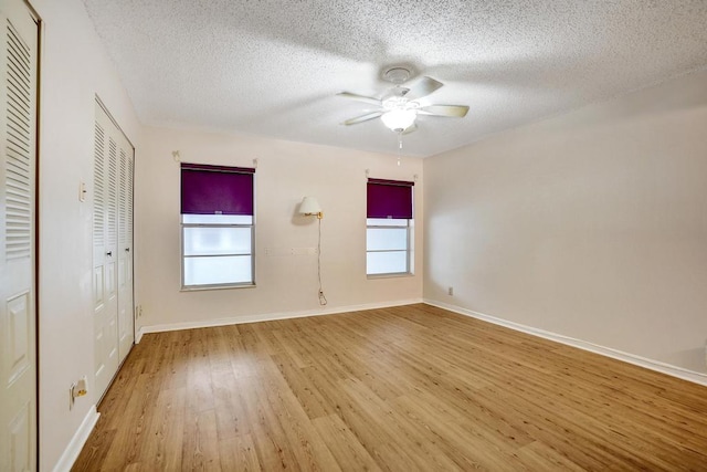 spare room with hardwood / wood-style floors, ceiling fan, and a textured ceiling