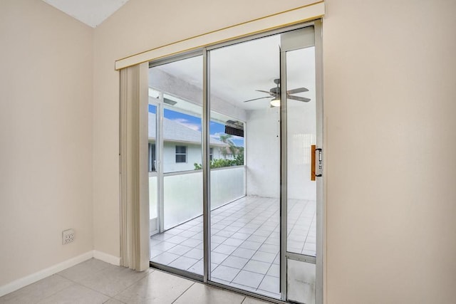 doorway to outside with ceiling fan and light tile patterned floors