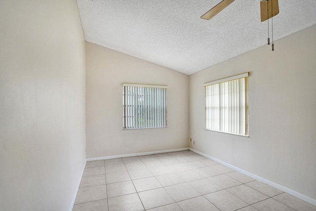 tiled spare room with ceiling fan, lofted ceiling, and a textured ceiling