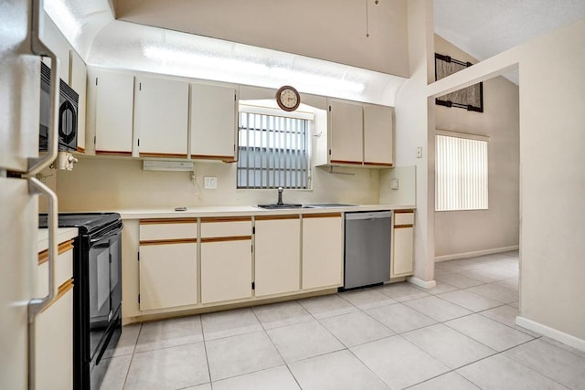 kitchen featuring sink, light tile patterned flooring, stainless steel appliances, and cream cabinetry