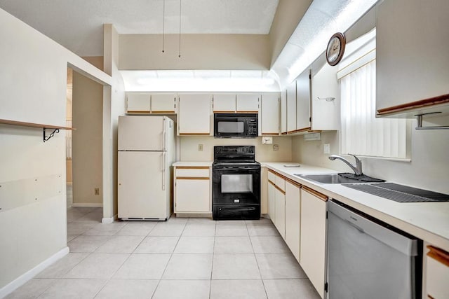 kitchen featuring black appliances, light tile patterned flooring, white cabinets, and sink