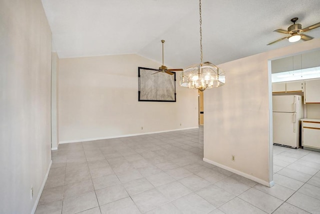 tiled spare room with ceiling fan with notable chandelier and vaulted ceiling