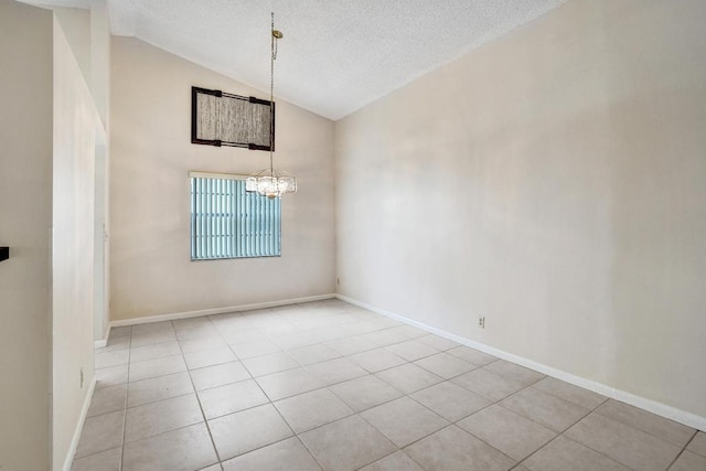 unfurnished dining area featuring a chandelier, light tile patterned floors, a textured ceiling, and high vaulted ceiling