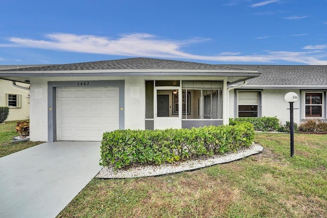 ranch-style house with a front lawn and a garage