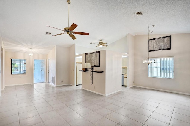 unfurnished living room featuring a textured ceiling, light tile patterned floors, ceiling fan with notable chandelier, and high vaulted ceiling