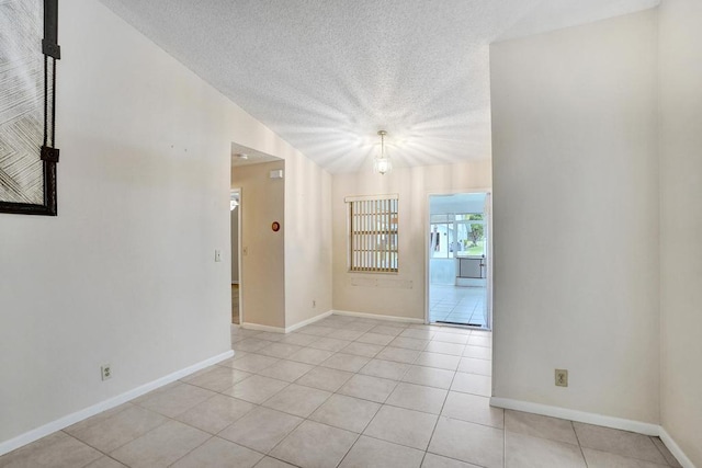 unfurnished room featuring light tile patterned floors and a textured ceiling