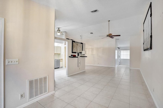 unfurnished living room with a textured ceiling, high vaulted ceiling, ceiling fan, and light tile patterned flooring