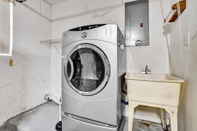 laundry area featuring electric panel and washer / clothes dryer