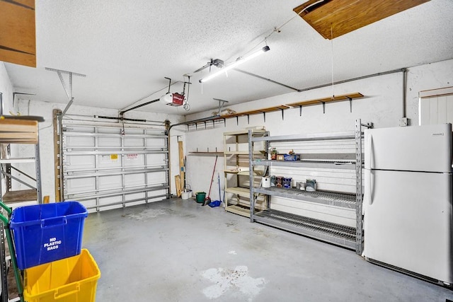 garage with white fridge and a garage door opener