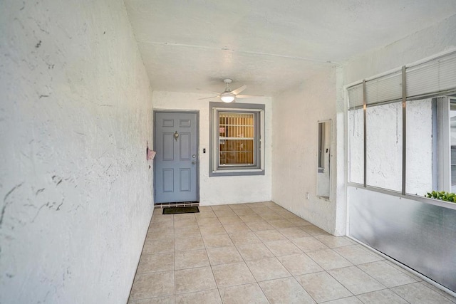 view of exterior entry with ceiling fan