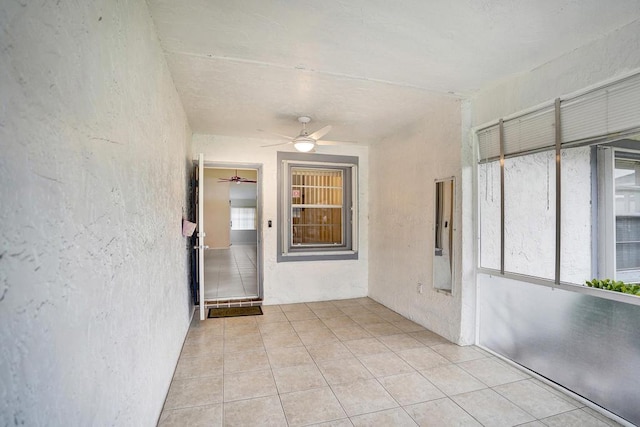 interior space with ceiling fan