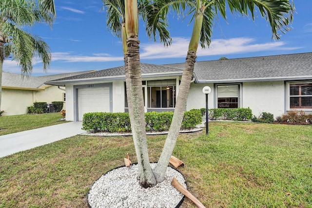 ranch-style home with a garage and a front lawn