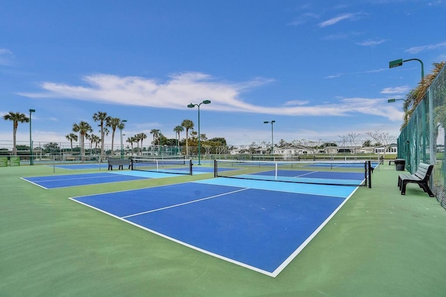 view of tennis court with basketball hoop