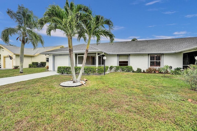 ranch-style house featuring a garage and a front lawn