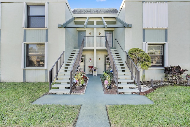 view of exterior entry with a lawn