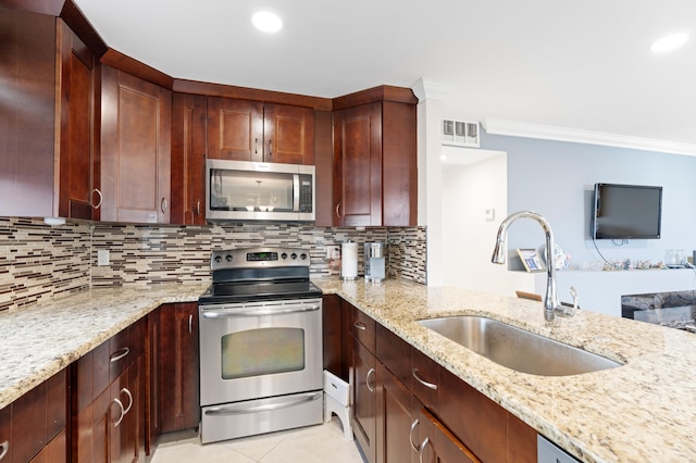 kitchen featuring sink, light stone countertops, ornamental molding, appliances with stainless steel finishes, and tasteful backsplash