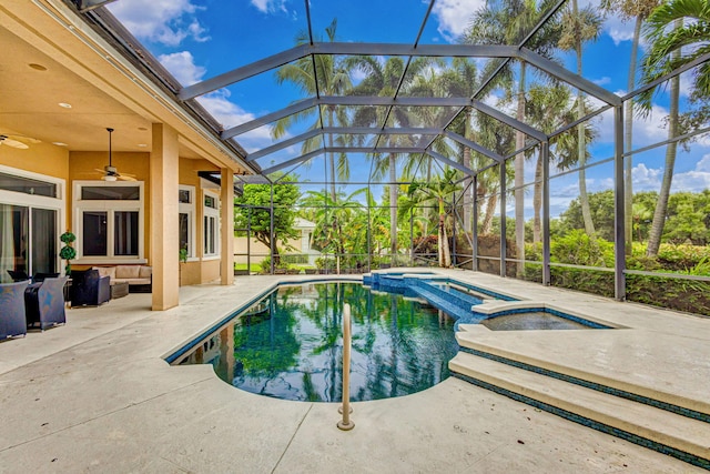 view of pool with an in ground hot tub, outdoor lounge area, ceiling fan, glass enclosure, and a patio