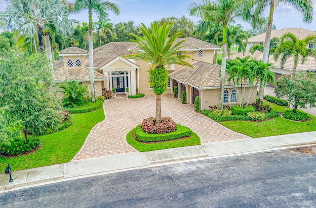 mediterranean / spanish-style home with a front yard