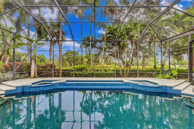 view of pool featuring a lanai and an in ground hot tub