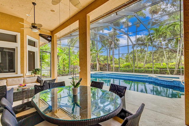 sunroom with ceiling fan, lofted ceiling, and a swimming pool