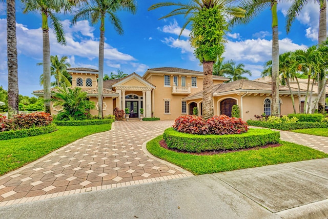 mediterranean / spanish-style home featuring a front yard