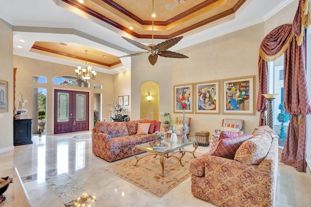 living room with a raised ceiling, crown molding, french doors, and a high ceiling