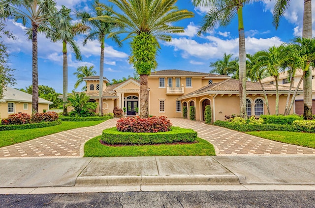 mediterranean / spanish house with a front yard