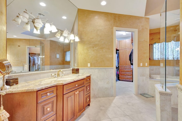 bathroom featuring tile patterned flooring, a shower, vaulted ceiling, vanity, and tile walls