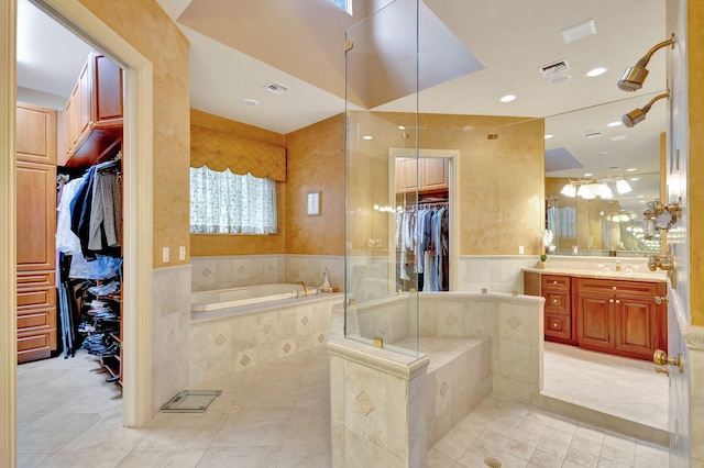 bathroom with tile patterned floors, vanity, and independent shower and bath