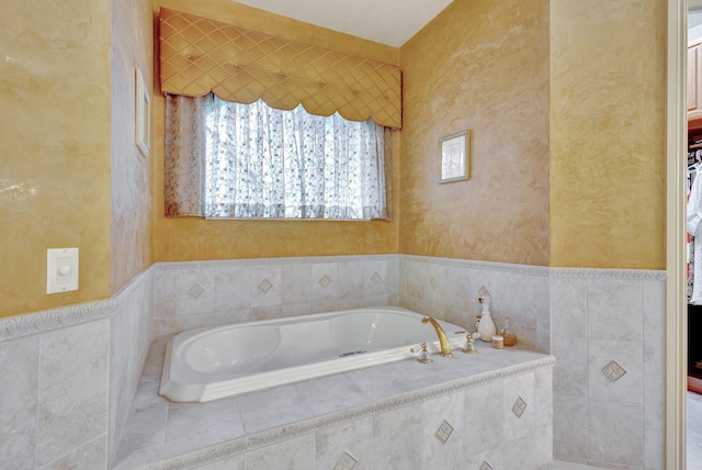 bathroom featuring tiled tub