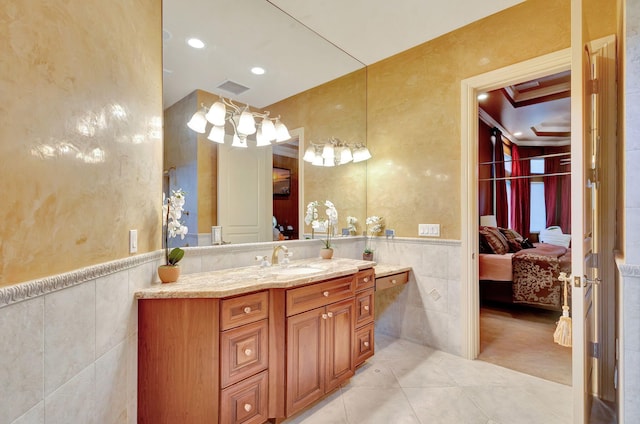 bathroom with tile patterned floors, vanity, tile walls, and ornamental molding