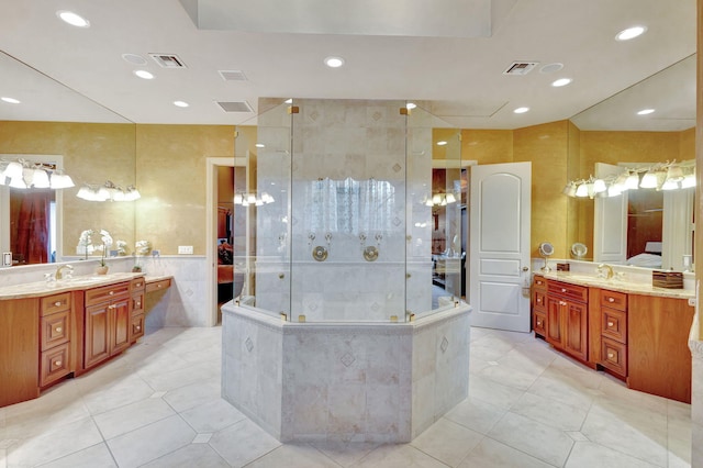 bathroom with tile patterned flooring, vanity, walk in shower, and tile walls