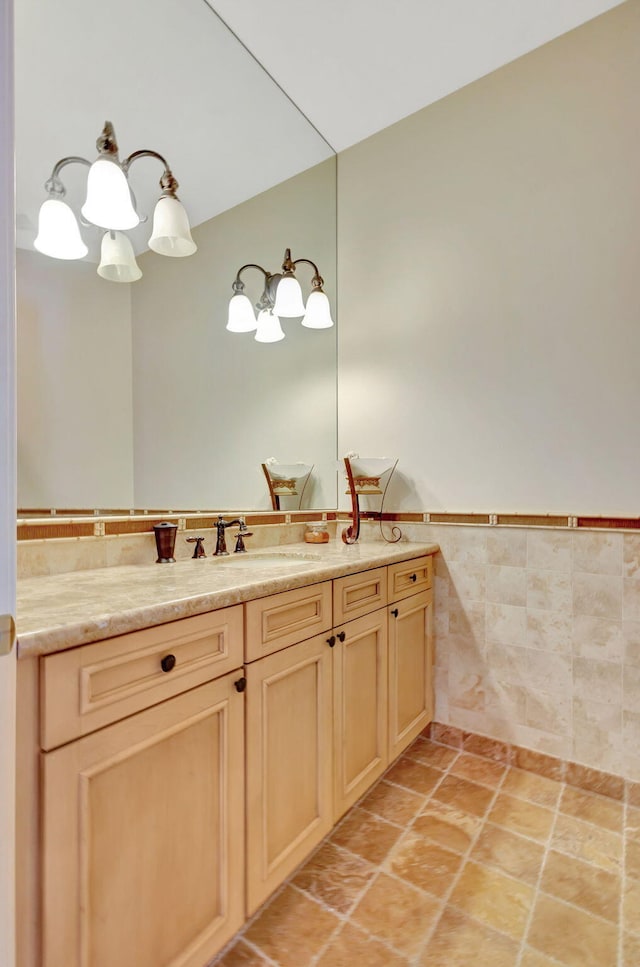 bathroom with vanity and tile walls