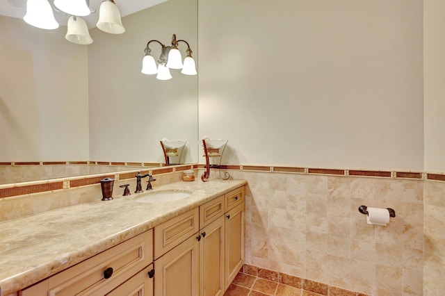 bathroom featuring vanity and tile walls