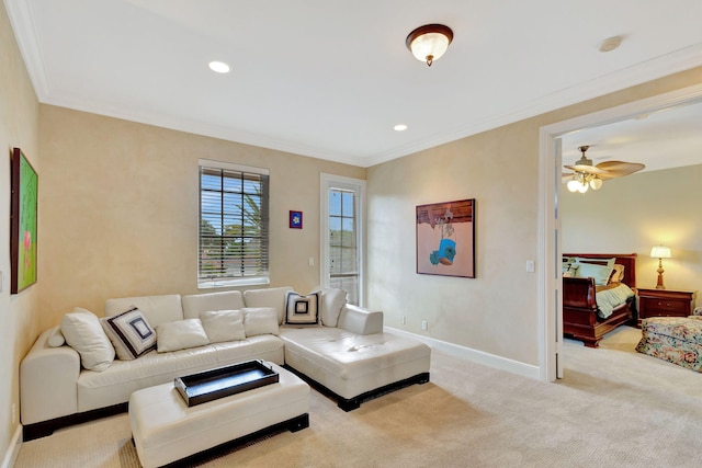 living room with crown molding, ceiling fan, and light colored carpet