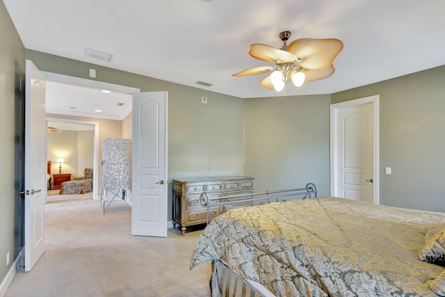 bedroom featuring ceiling fan and light carpet