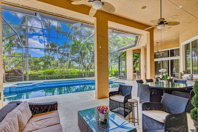 exterior space featuring ceiling fan and an in ground hot tub