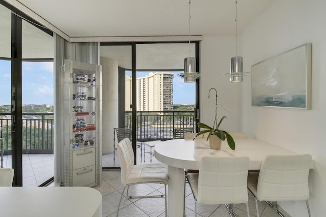 dining area featuring floor to ceiling windows and light tile patterned floors