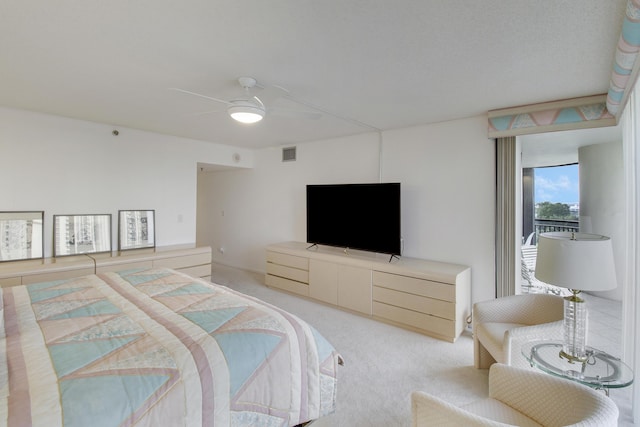 bedroom with ceiling fan and light carpet