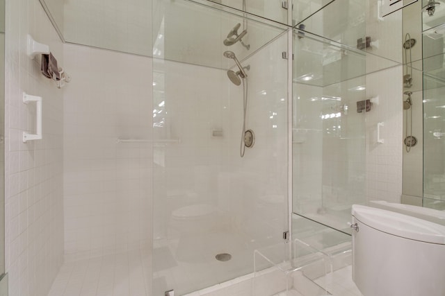 bathroom featuring toilet and an enclosed shower