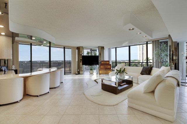 living room featuring expansive windows, light tile patterned flooring, and a wealth of natural light