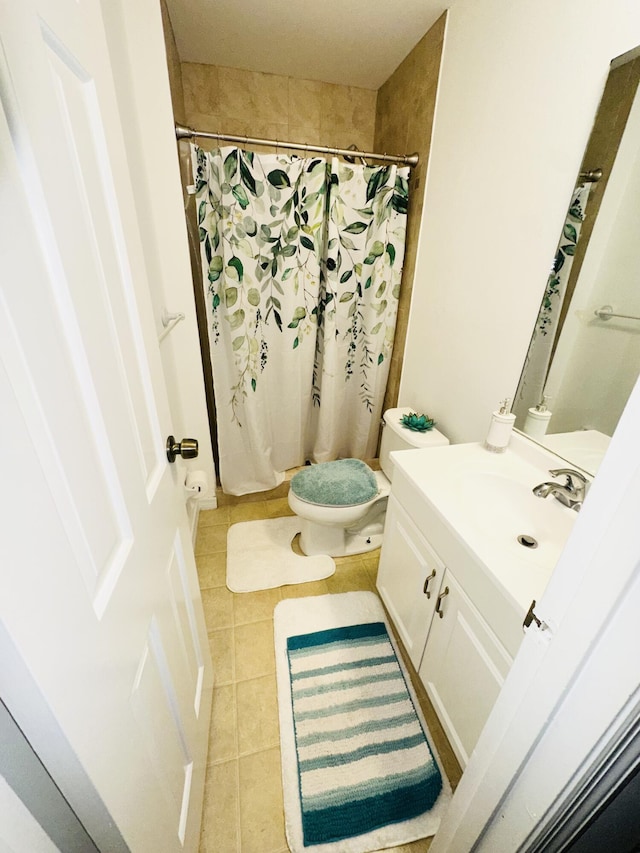 bathroom with toilet, vanity, tile patterned floors, and a shower with shower curtain