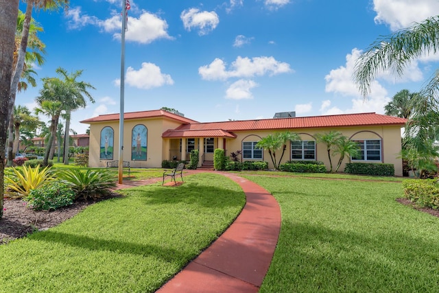 mediterranean / spanish-style house with a front yard