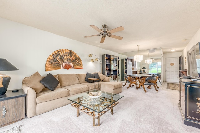 living room featuring carpet, a textured ceiling, and ceiling fan