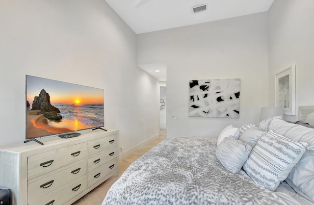 bedroom with high vaulted ceiling